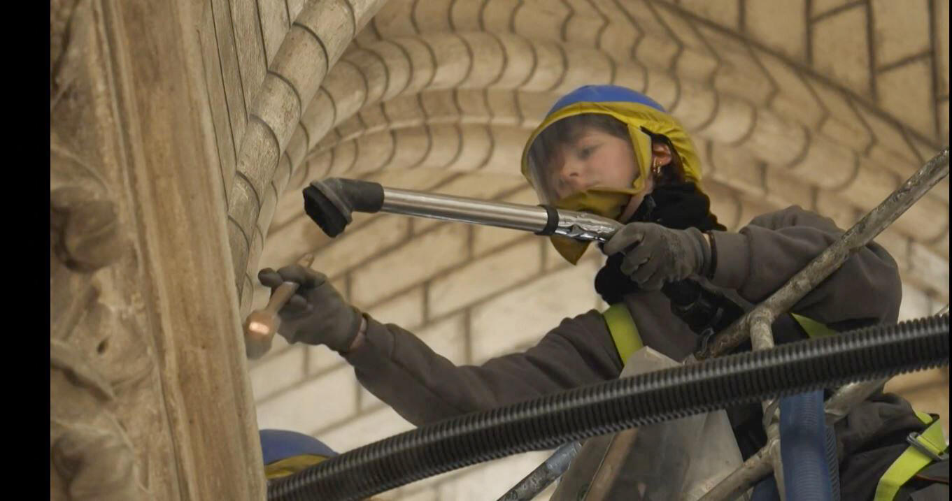 A staff member use a vacuum cleaner inside Notre-Dame de Paris on April 13, 2022.