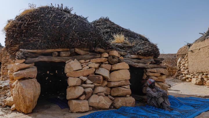 File photo: A man sits outside a traditional Dogon stone house in Bandiagara on February 26, 2024.