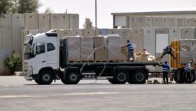 A truck carrying humanitarian aid for the Gaza Strip is loaded at the Kerem Shalom border crossing between southern Israel and Gaza on June 17, 2024.