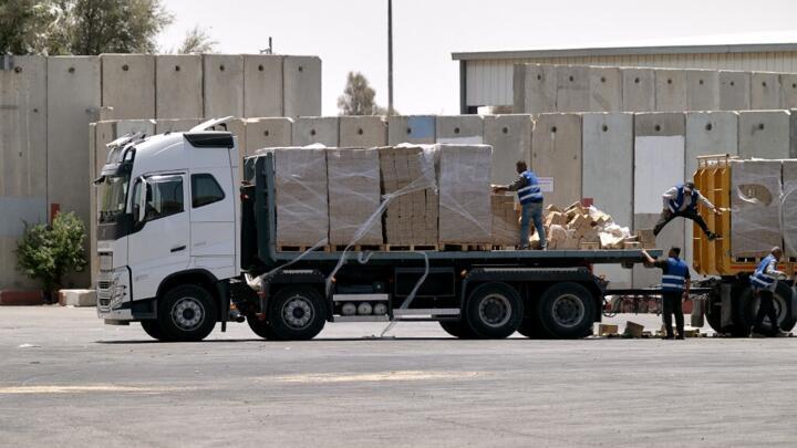 A truck carrying humanitarian aid for the Gaza Strip is loaded at the Kerem Shalom border crossing between southern Israel and Gaza on June 17, 2024.