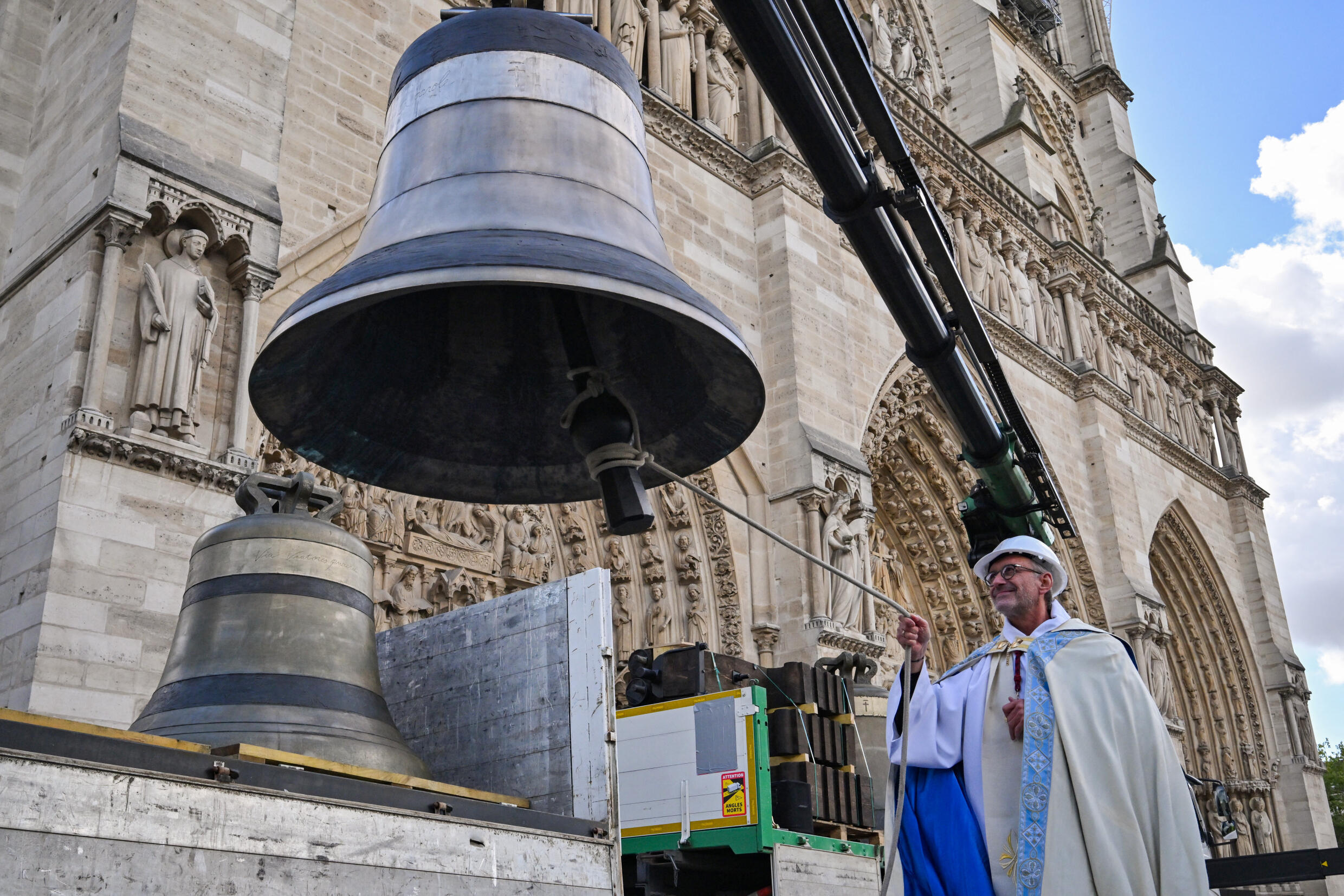 Rector of Notre-Dame Cathedral Olivier Ribadeau Dumas blesses one the eight bells of the north belfry of Notre-Dame on September 12, 2024.