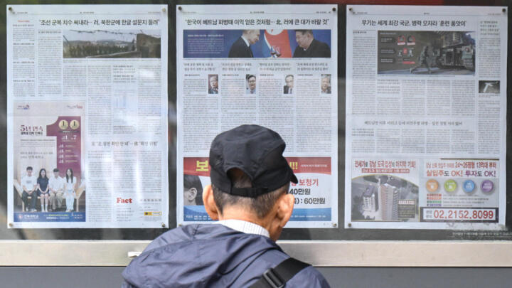 A Seoul resident reads a newspaper article on North Korea's troop deployments in Ukraine on October 21, 2024.