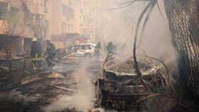 In this handout photograph taken and released by the Ukrainian Emergency Service on November 18, 2024, Ukrainian rescuers work at the site of a missile attack in Odesa.