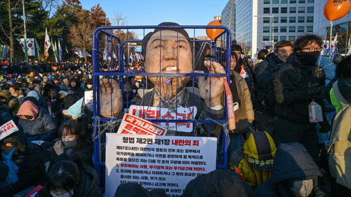 Protesters calling for the ouster of South Korea President Yoon Suk Yeol gather for the outcome of the second martial law impeachment vote outside the National Assembly in Seoul on December 14, 2024. 