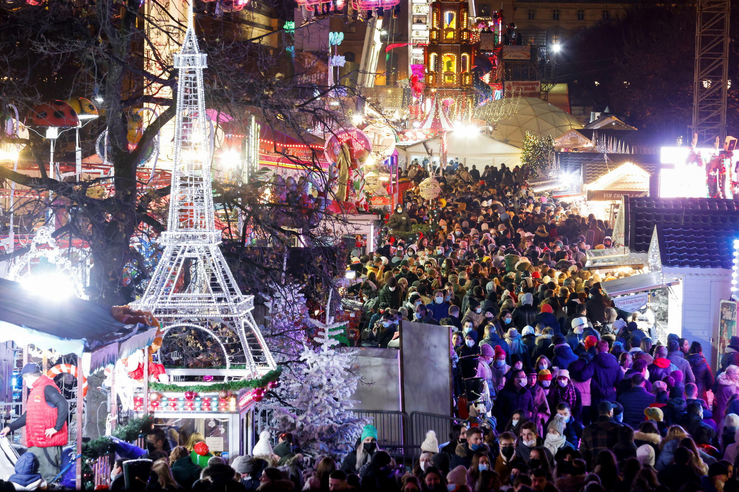 Crowds walk through the Christmas market in the Tuileries Garden in Paris, France, November 27, 2021.