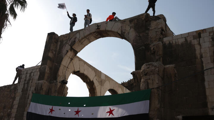 Syrians wave the independence-era flag after midday prayers at the Umayyad Mosque in Damascus on Friday.