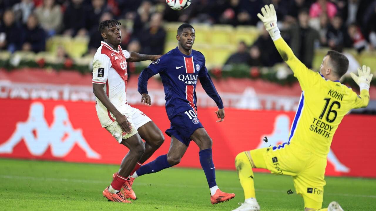 Monaco's Ivorian defender #17 Wilfried Singo (L) fights for the ball with Paris Saint-Germain's French forward #10 Ousmane Dembele, Louis II Stadium, Monaco, December 18, 2024.