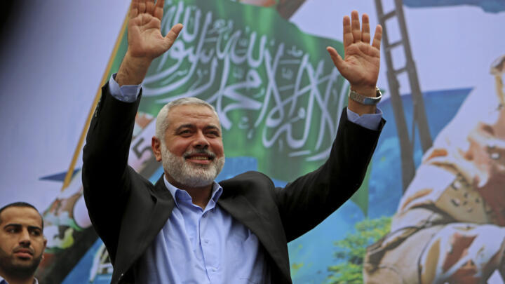 In this file photo, Palestinian top Hamas leader Ismail Haniyeh greets supporters during a rally to commemorate the 27th anniversary of the Hamas militant group, at the main road in Jebaliya in the northern Gaza Strip, on December 12, 2014.
