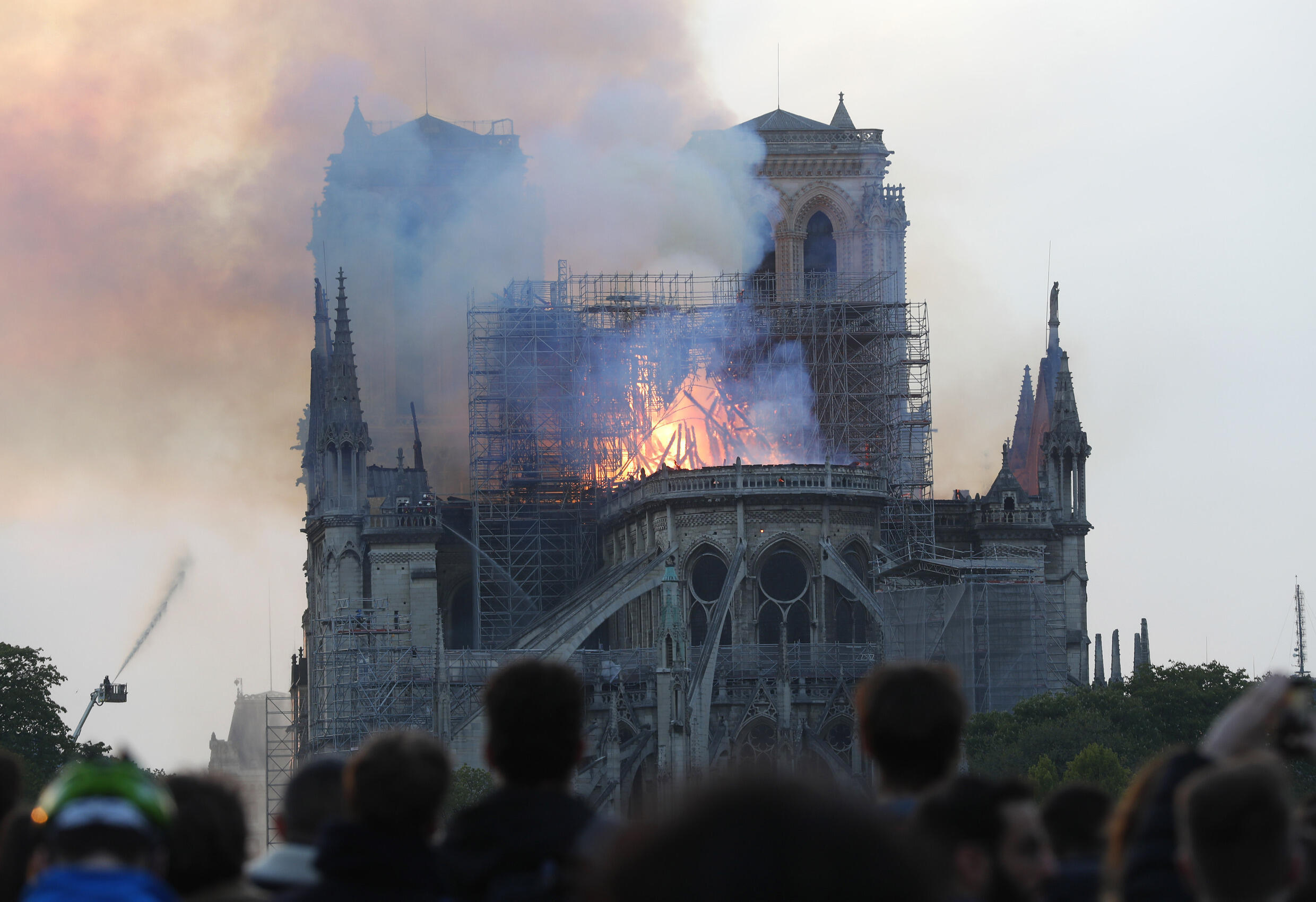 Parisians watch stunned as smoke rises from Notre-Dame de Paris on April 15, 2019.