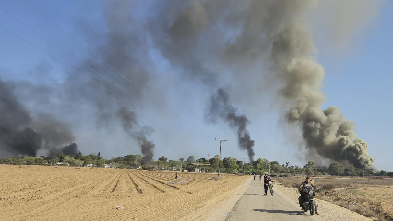 Palestinians on the outskirts of a kibbutz, near the border fence with the Gaza Strip, during the deadly cross-border attack in southern Israel on Saturday, Oct. 7, 2023.