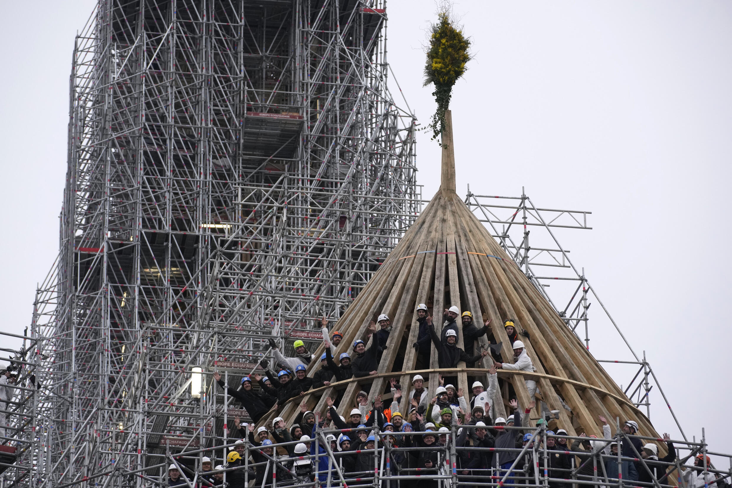 Workers celebrate reconstructing the cathedral framework with a traditional bouquet of flowers on January 12, 2024