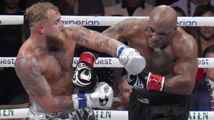 Jake Paul, left, fights Mike Tyson during their heavyweight boxing match on November 15, 2024 in Arlington, Texas.