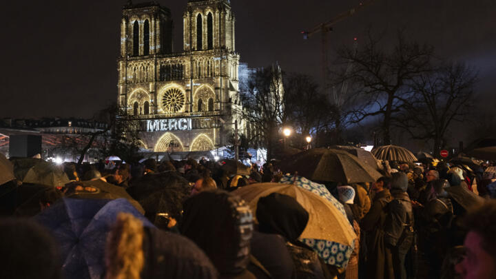Spectators gather outside France's iconic Notre-Dame Cathedral on December 7, 2024.