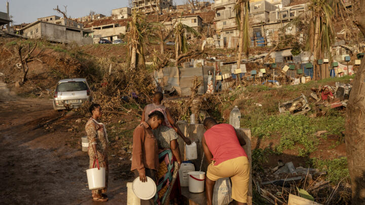 People line up to collect water in Barakani, Mayotte, on December 21, 2024.