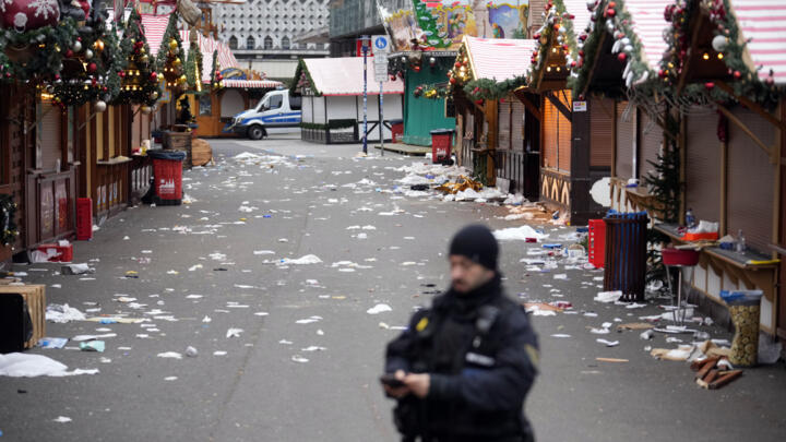 A police officer stands guard on December 21, 2024, at the Christmas Market where a car drove into a crowd in Magdeburg, Germany.