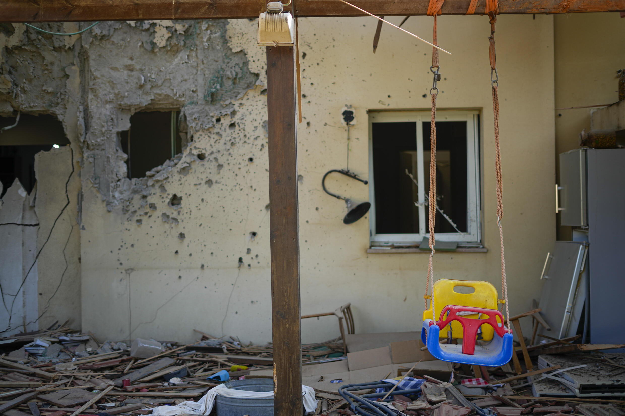 A children's swing hangs outside a house in the Be'eri kibbituz, Israel, which was overrun by Hamas militants during the attack of October 7, 2023.