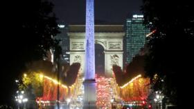 Christmas holiday lights decorate trees along the Champs-Élysées in Paris, France, on November 25, 2020. 