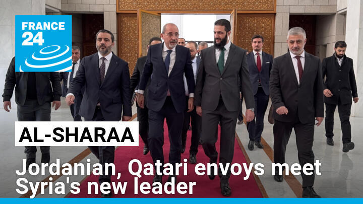 Jordanian Foreign Minister Ayman Safadi (C-L) is received by new Syrian leader Ahmed al-Sharaa (C-R) in Damascus on Monday.