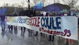 Teachers and parents rally on April 4, 2024, outside the brand new Olympic Aquatic Centre in Saint-Denis, north of Paris, to call for urgent measures in support of struggling schools.